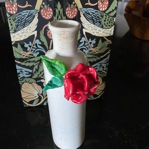 Ceramic vase adorned with ceramic flower